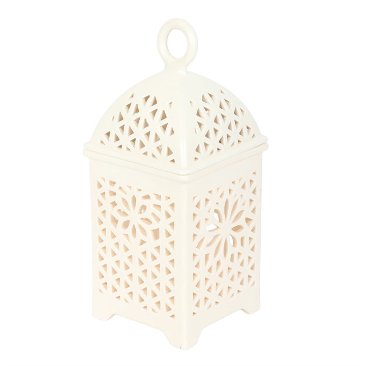 White lantern with intricate cut-out patterns on a white background