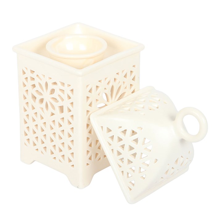 Decorative white lantern with intricate cut-out patterns on a white background