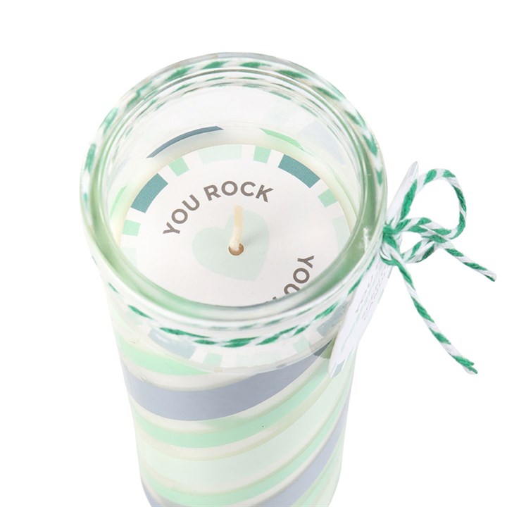Candle in a striped jar with 'YOU ROCK' text on a white background
