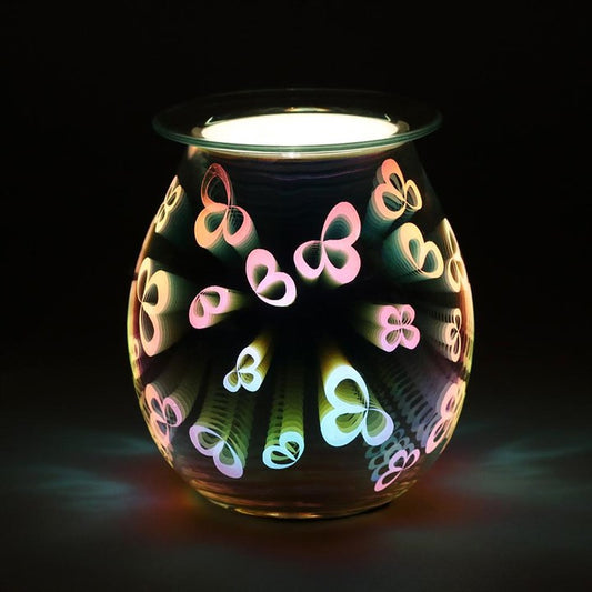 Decorative glass warmer with colorful butterfly designs on a black background