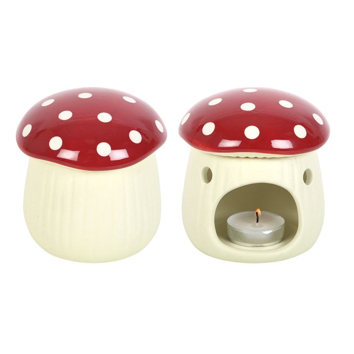 Two mushroom-shaped ceramic warmers with red caps and white spots on a white background.