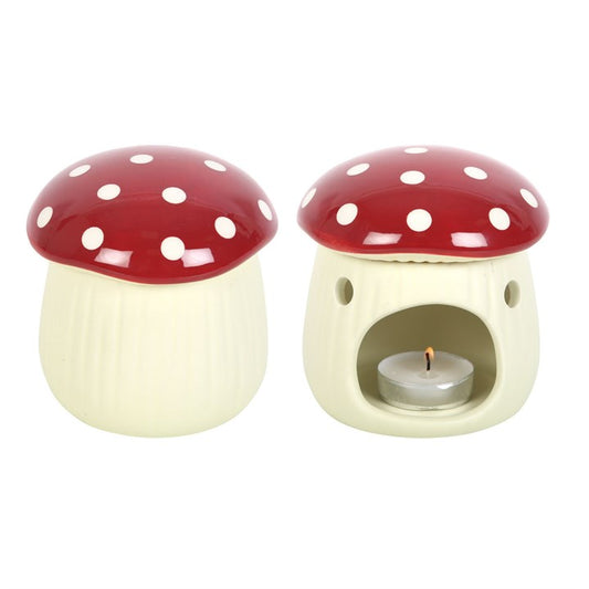 Two mushroom-shaped ceramic warmers with red caps and white spots on a white background.