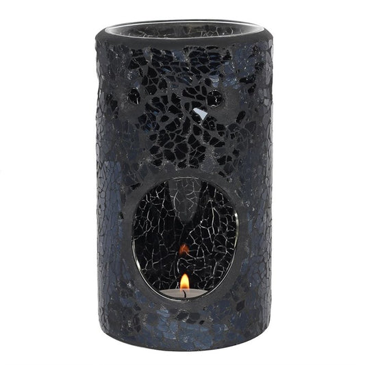 Black mosaic candle holder with a small flame inside on a white background
