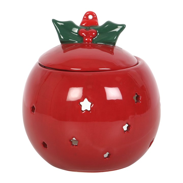 Red ceramic ball with star patterns and a green holly leaf on top against a white background