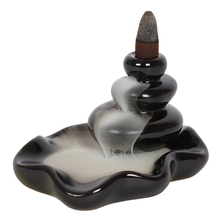 Cylindrical incense burner with wavy design on a white background