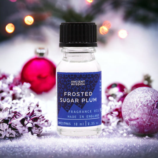 Frosted Sugar Plum fragrance oil bottle with festive decorations in the background