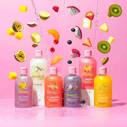 Bottles of bubble bath with fruit-themed packaging on a pink background