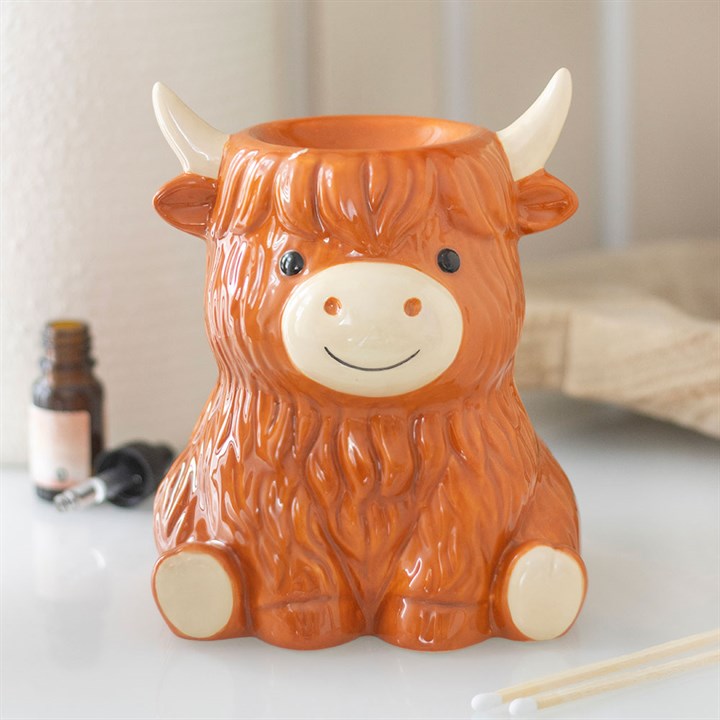 Ceramic cow-shaped container on a light surface with a blurred background