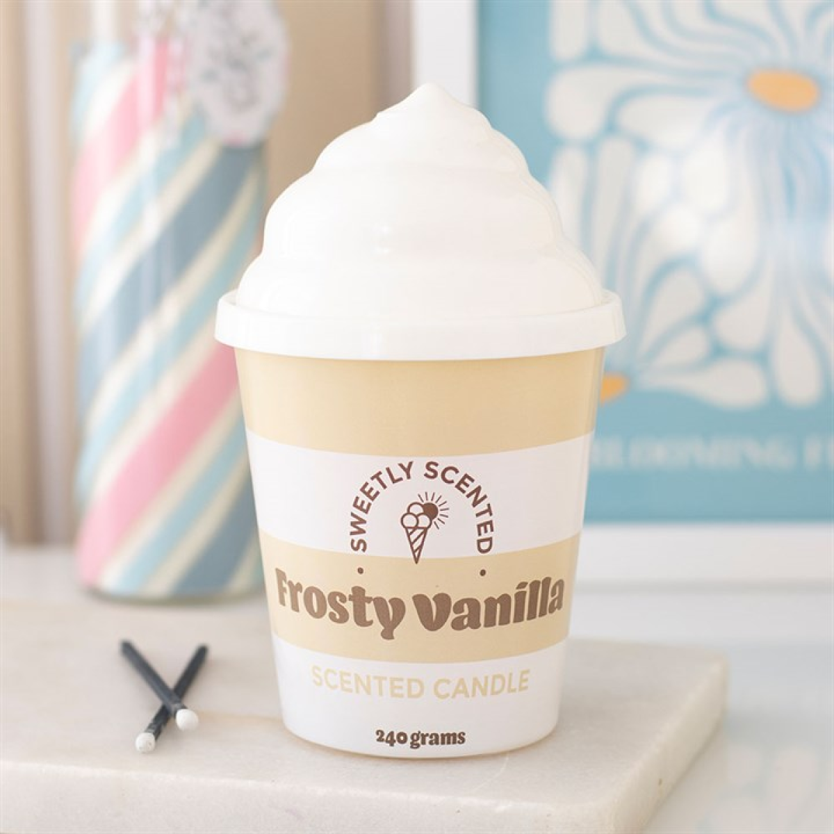 Frosty Vanilla scented candle in a cup with decorative background