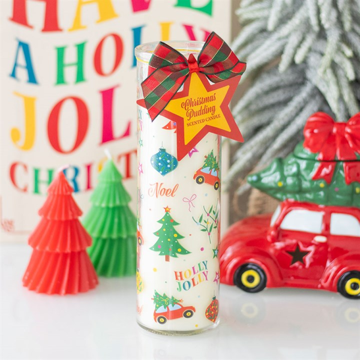 Decorative glass with Christmas-themed design and festive decorations in the background