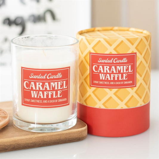 Two scented candles labeled 'Caramel Waffle' on a white surface.