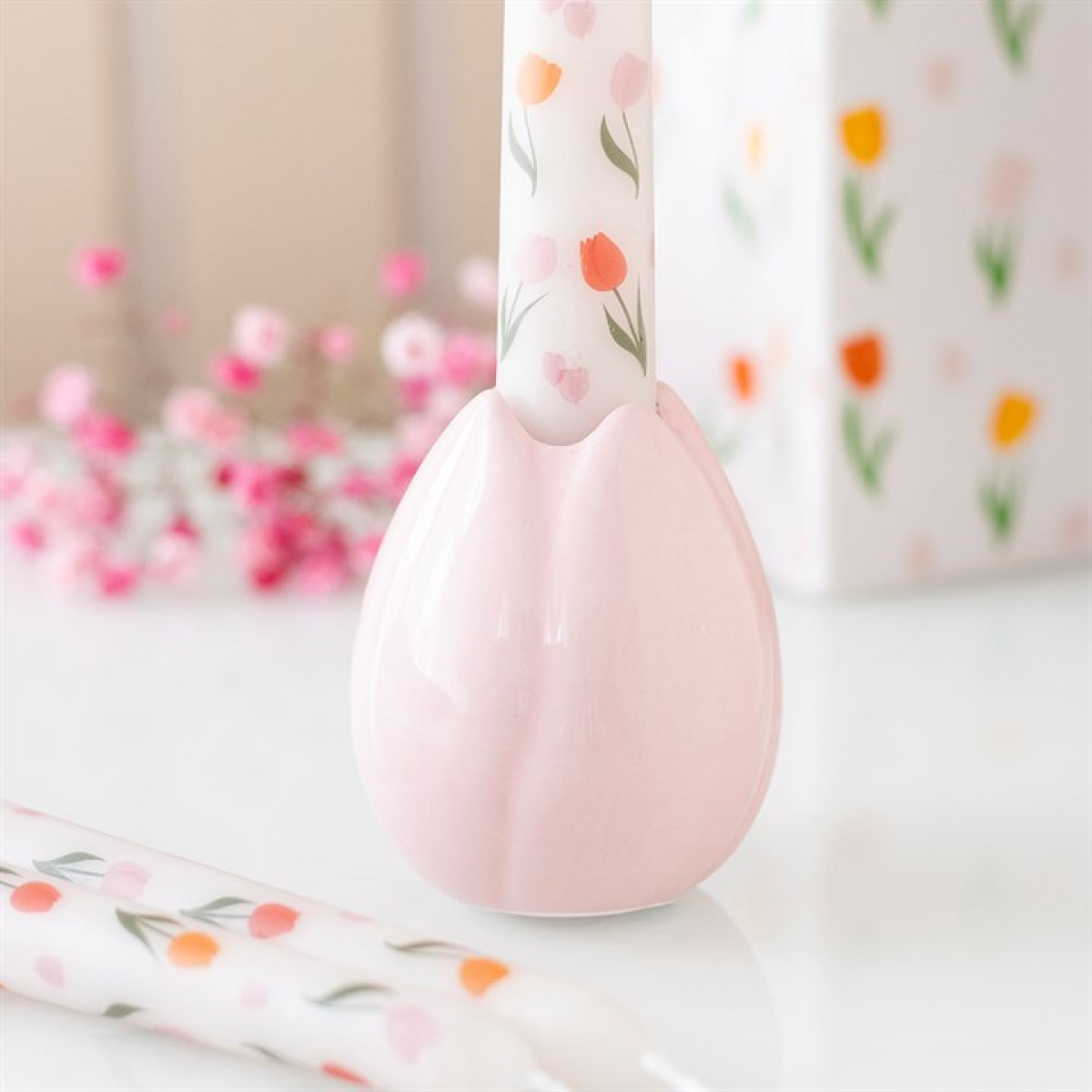 Pink ceramic spoon rest with floral design on a white surface