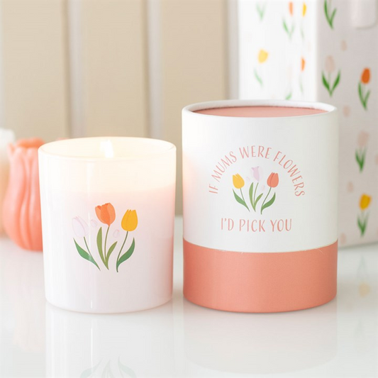 Two candles with floral designs and text on a light background